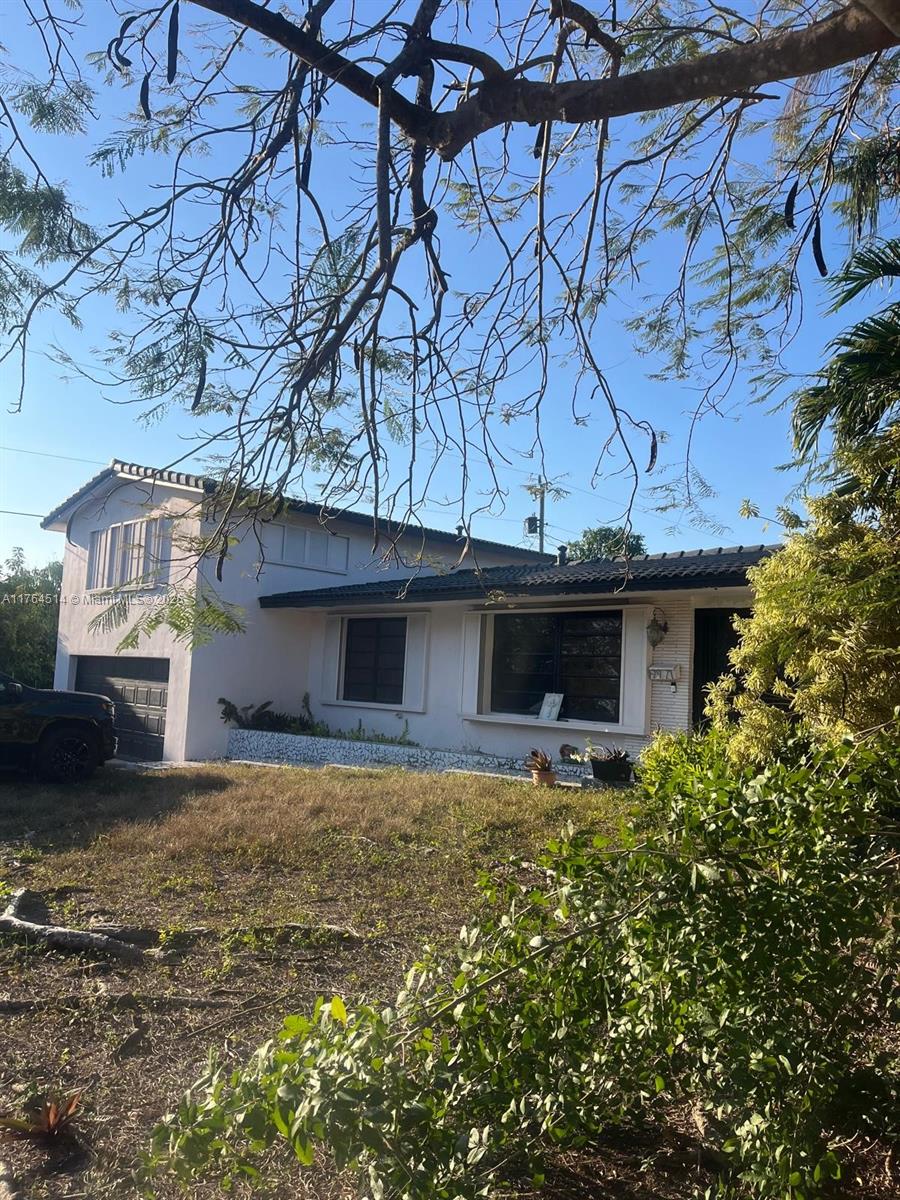 9971 Colonial Drive Miami, FL 33157 - Photo 3 of 7 a house that has a tree in front of it