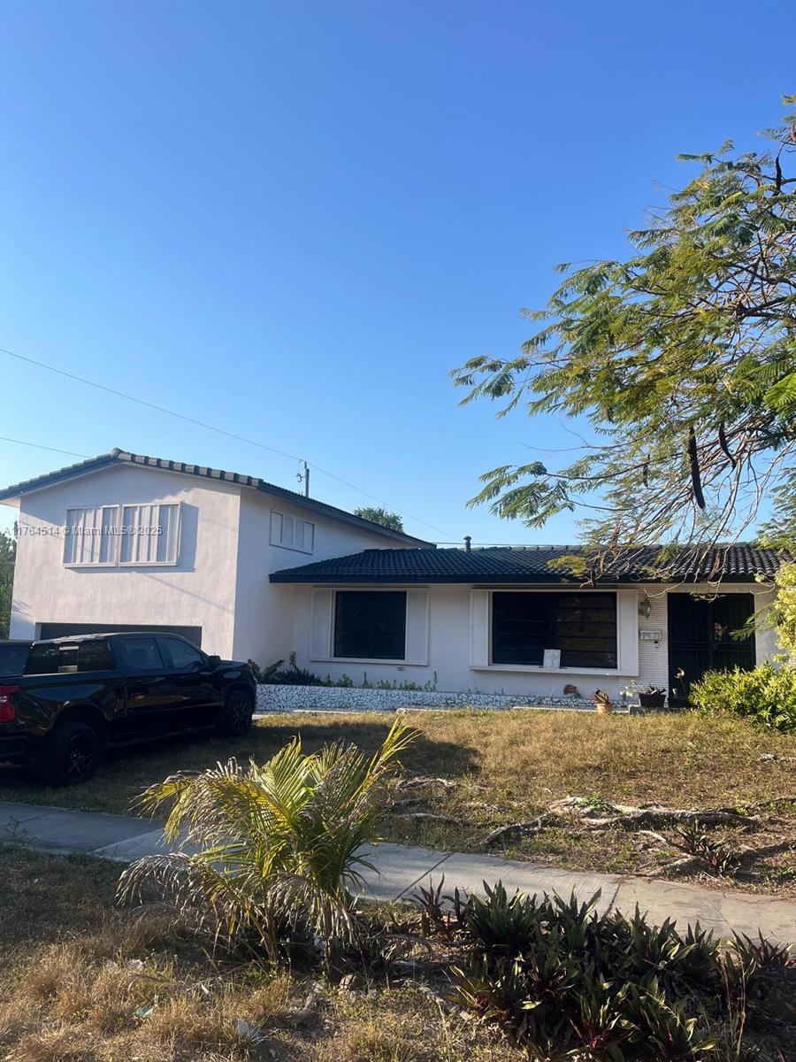 9971 Colonial Drive Miami, FL 33157 - Photo 5 of 7 a front view of a house with a yard