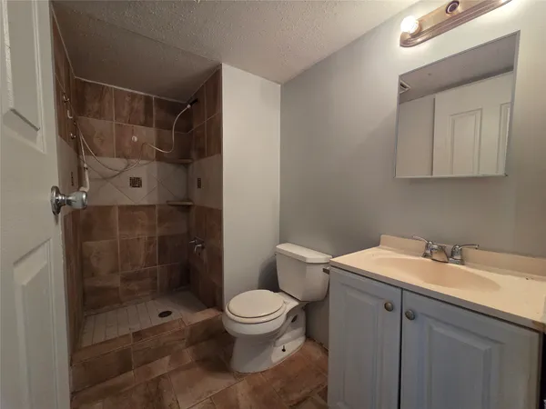 a bathroom with a shower toilet and sink