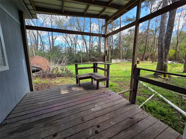 a view of a deck with wooden floor and wooden stairs