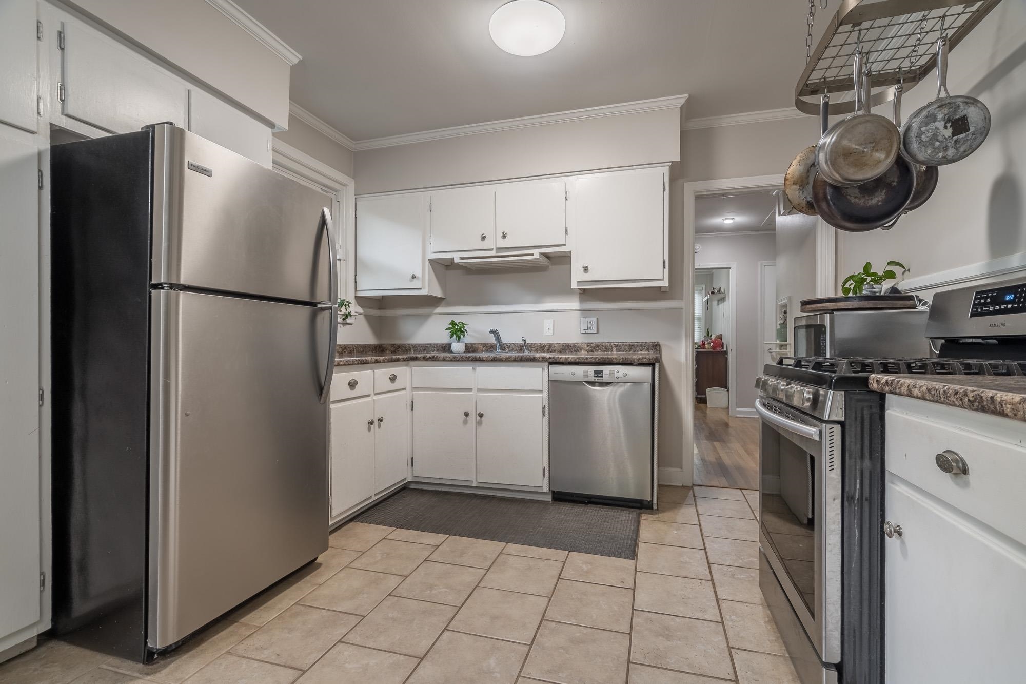 5003 Sequoia Road Memphis, TN 38117 - Photo 5 of 15 a kitchen with a stove top oven and refrigerator
