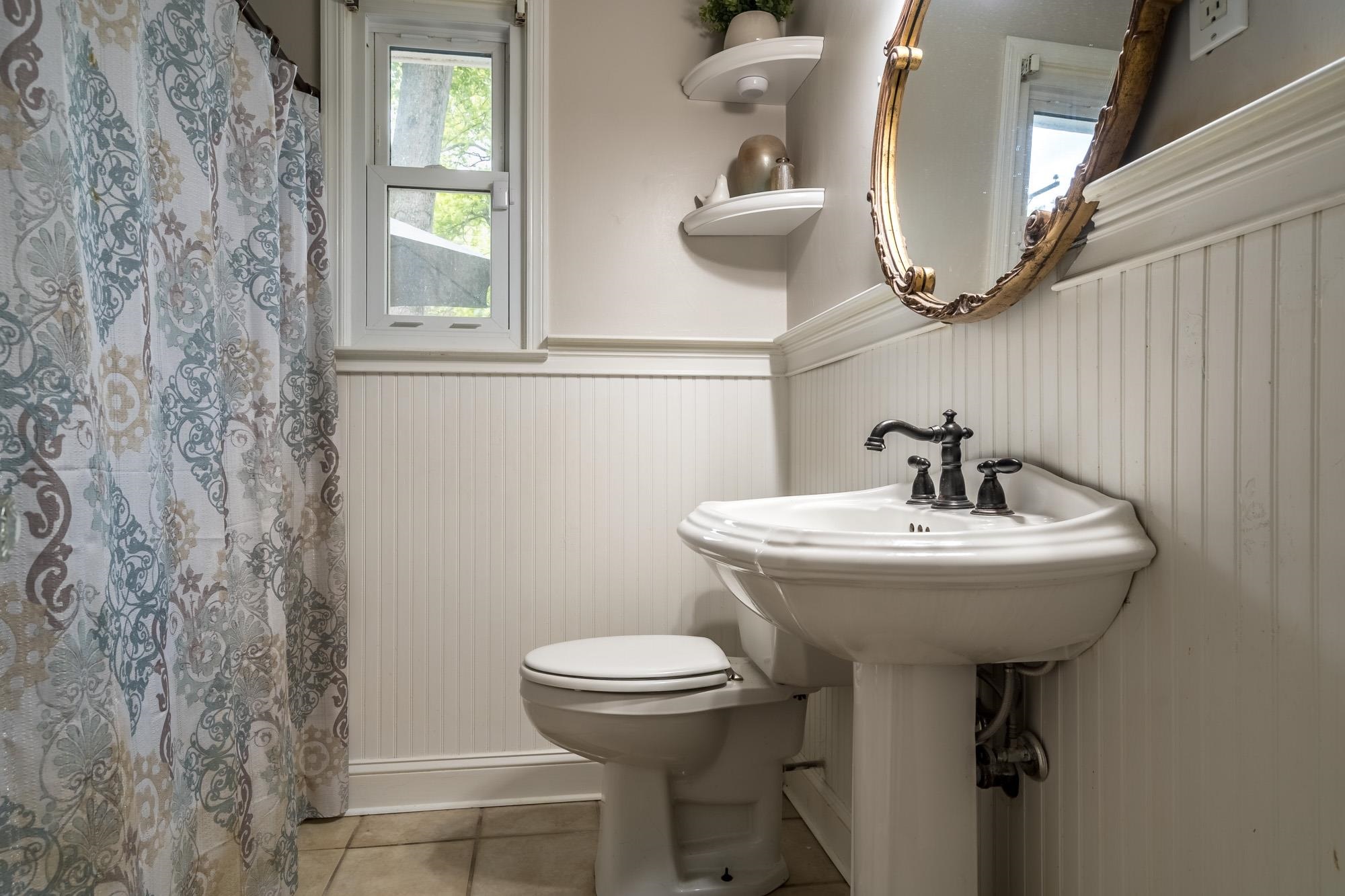 5003 Sequoia Road Memphis, TN 38117 - Photo 10 of 15 a bathroom with a sink a mirror and toilet
