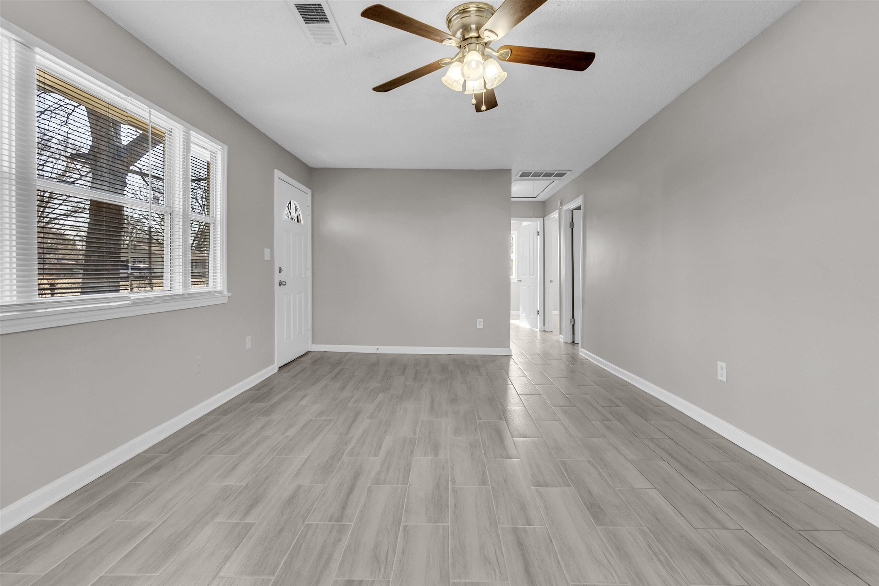 7821 Newport Road Millington, TN 38053 - Photo 13 of 18 Empty room with ceiling fan and wood finish floors