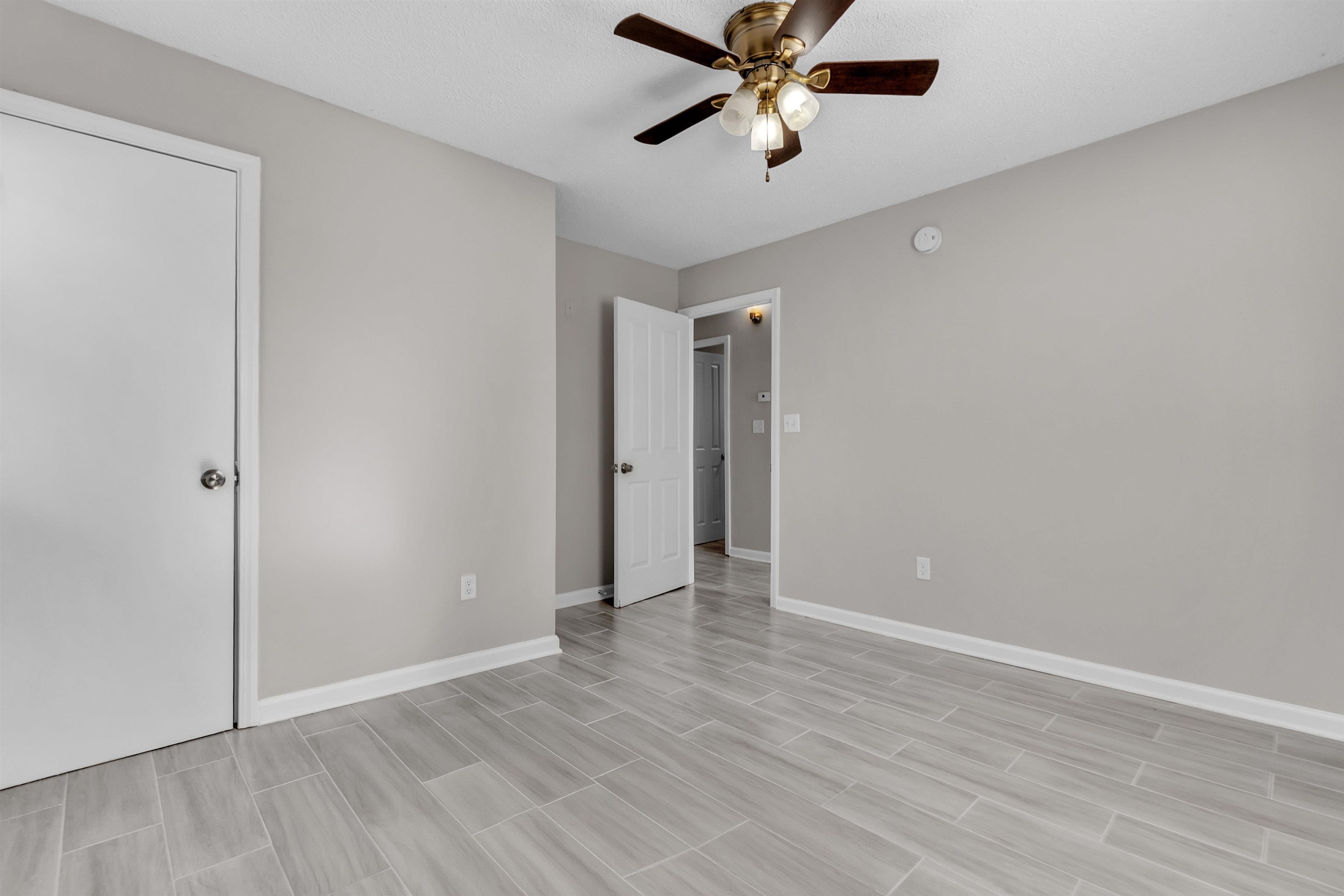 7821 Newport Road Millington, TN 38053 - Photo 14 of 18 Unfurnished bedroom with a ceiling fan and wood finish floors