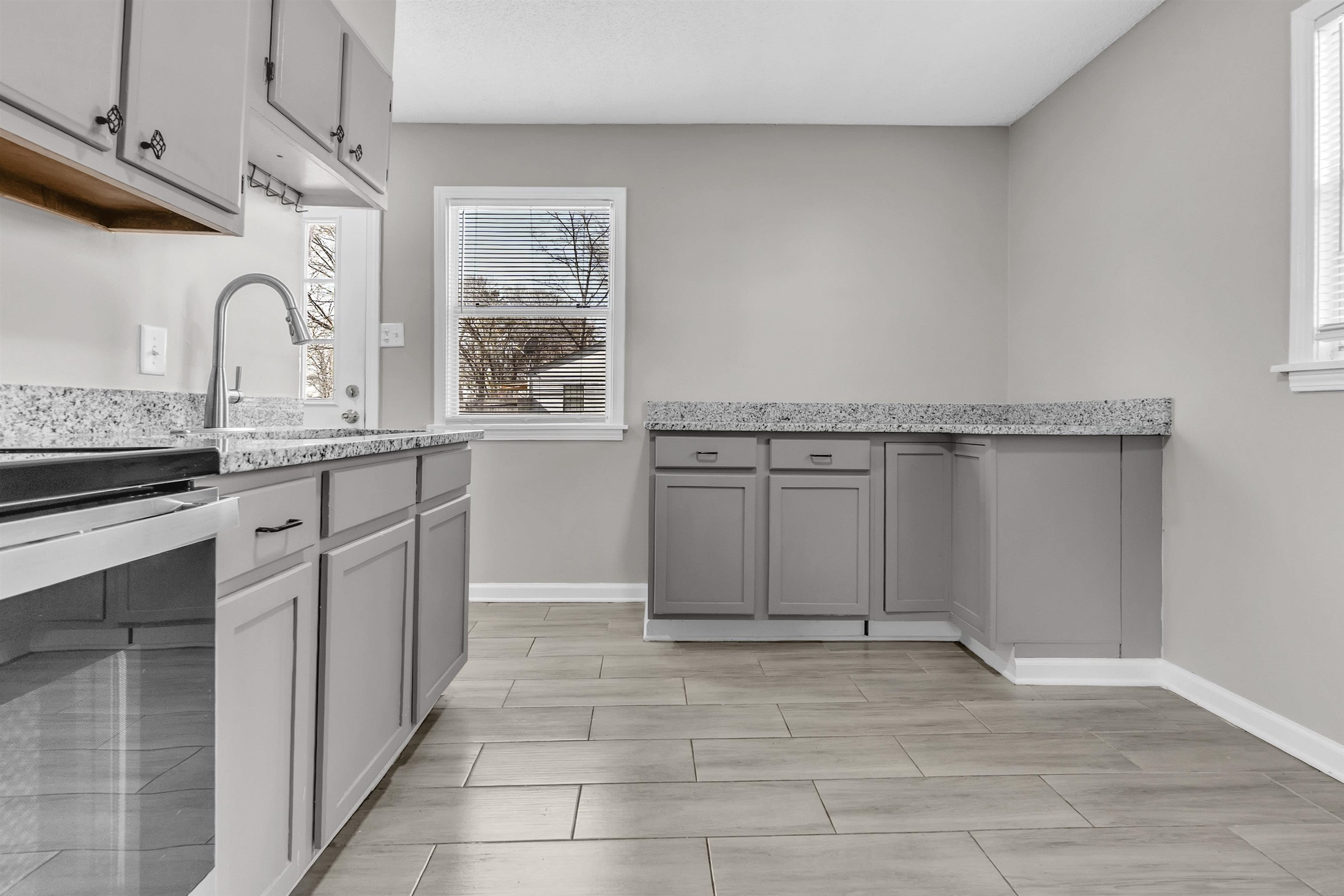 7821 Newport Road Millington, TN 38053 - Photo 4 of 18 Kitchen featuring gray cabinets, light stone countertops, beverage cooler, and wood tiled floors
