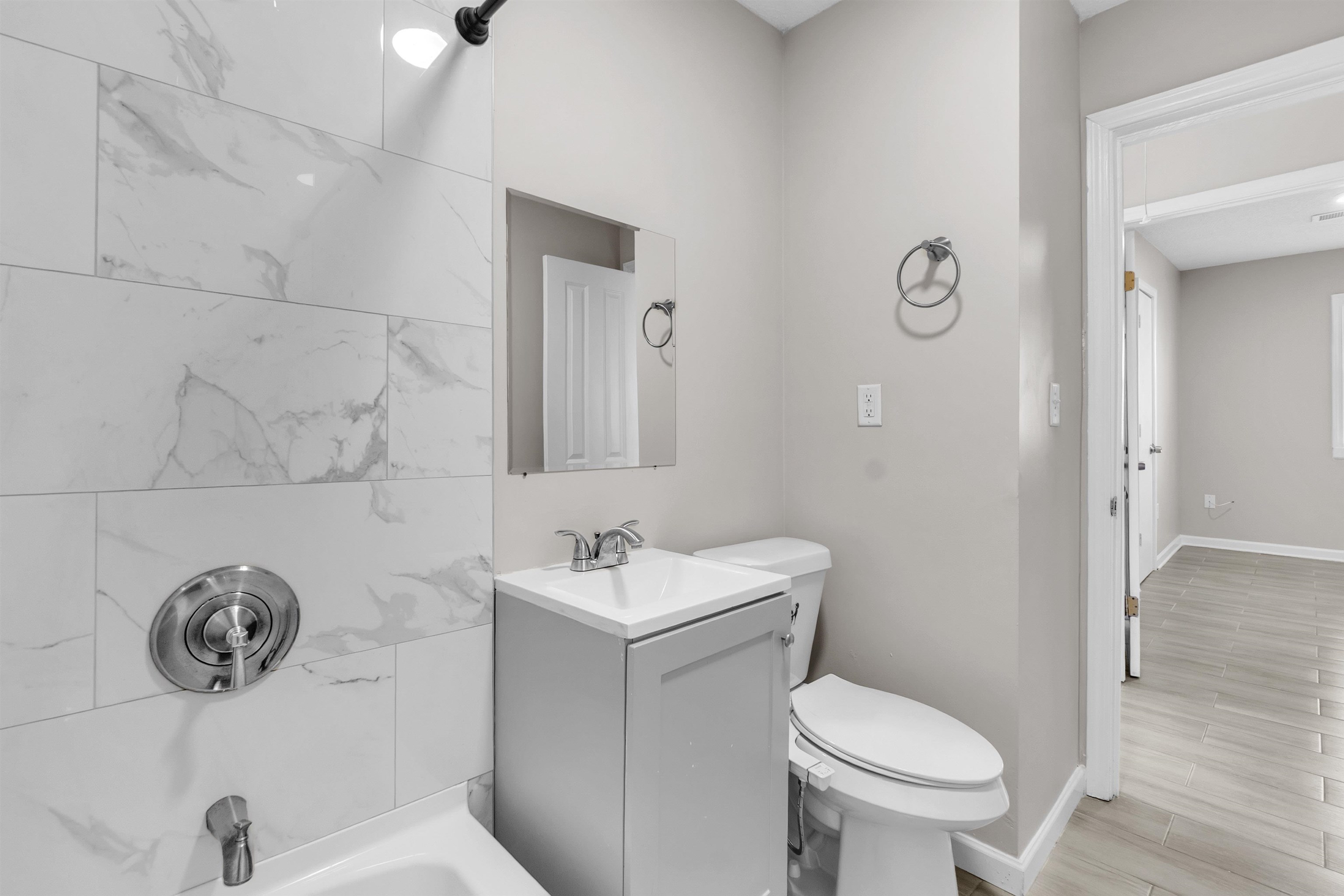 7821 Newport Road Millington, TN 38053 - Photo 6 of 18 Bathroom featuring shower / tub combination, vanity, and wood finish floors