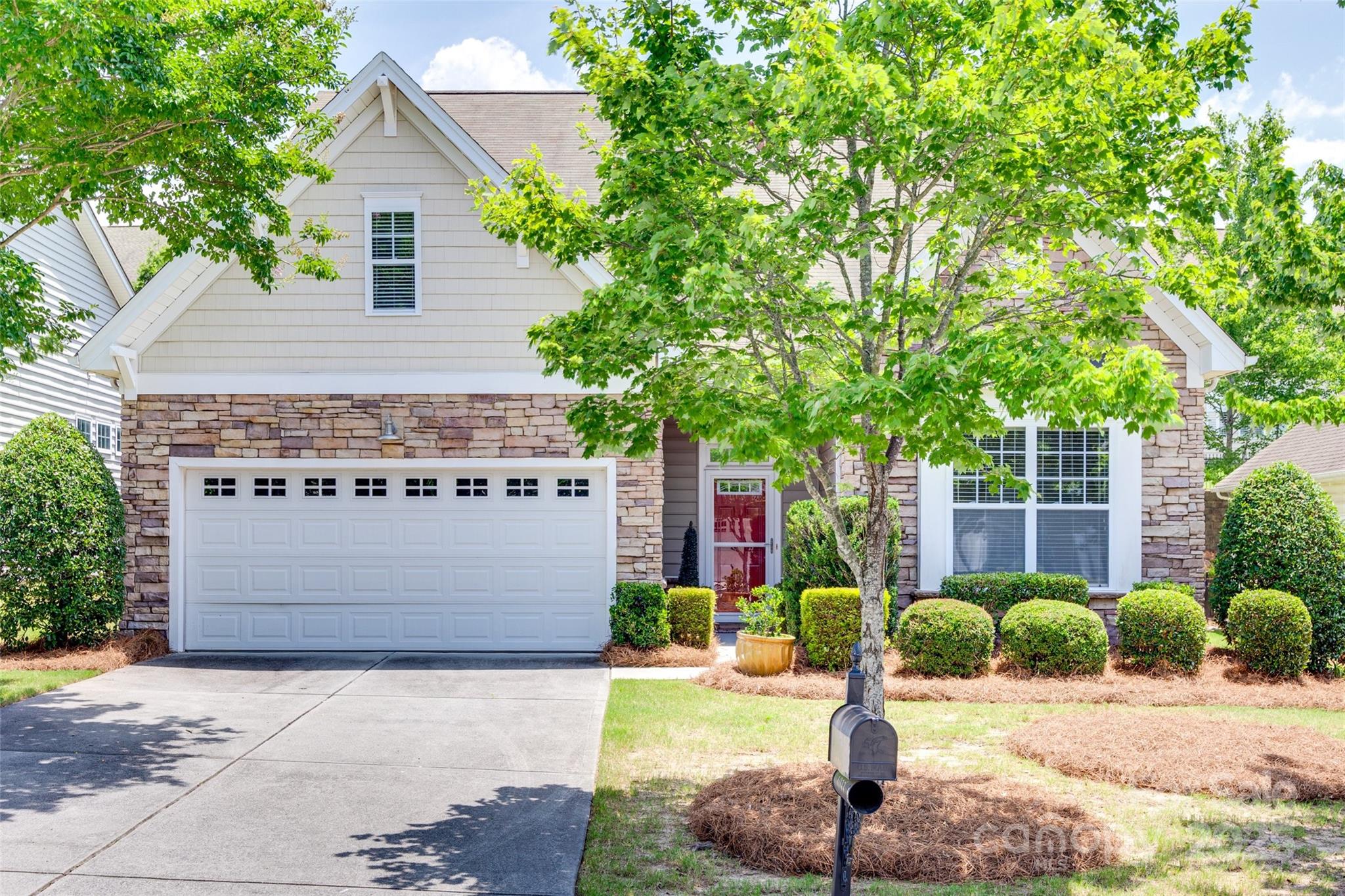 a front view of a house with a garden