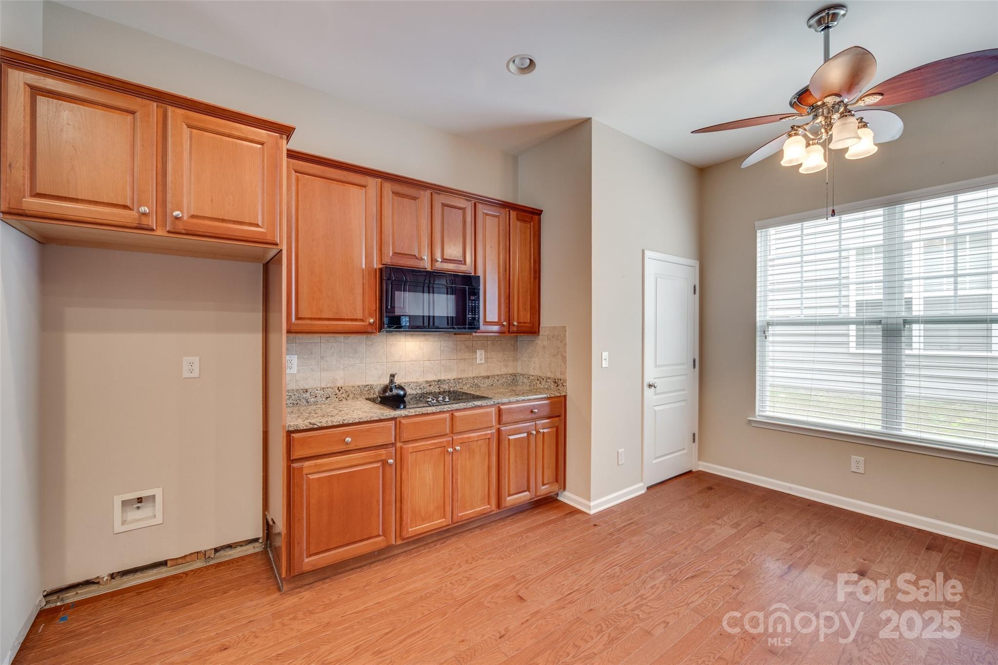 1033 Knob Creek Lane Tega Cay, SC 29708 - Photo 12 of 45 a kitchen with stainless steel appliances granite countertop a stove a sink and a refrigerator with wooden cabinets