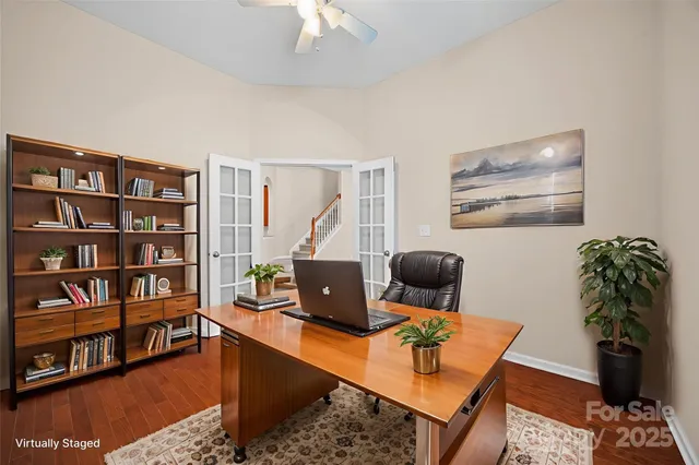 a living room with furniture and a book shelf