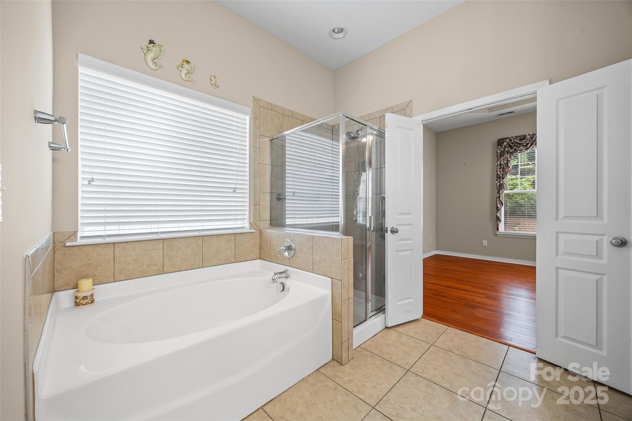 1033 Knob Creek Lane Tega Cay, SC 29708 - Photo 24 of 45 a bathroom with a bathtub and a shower