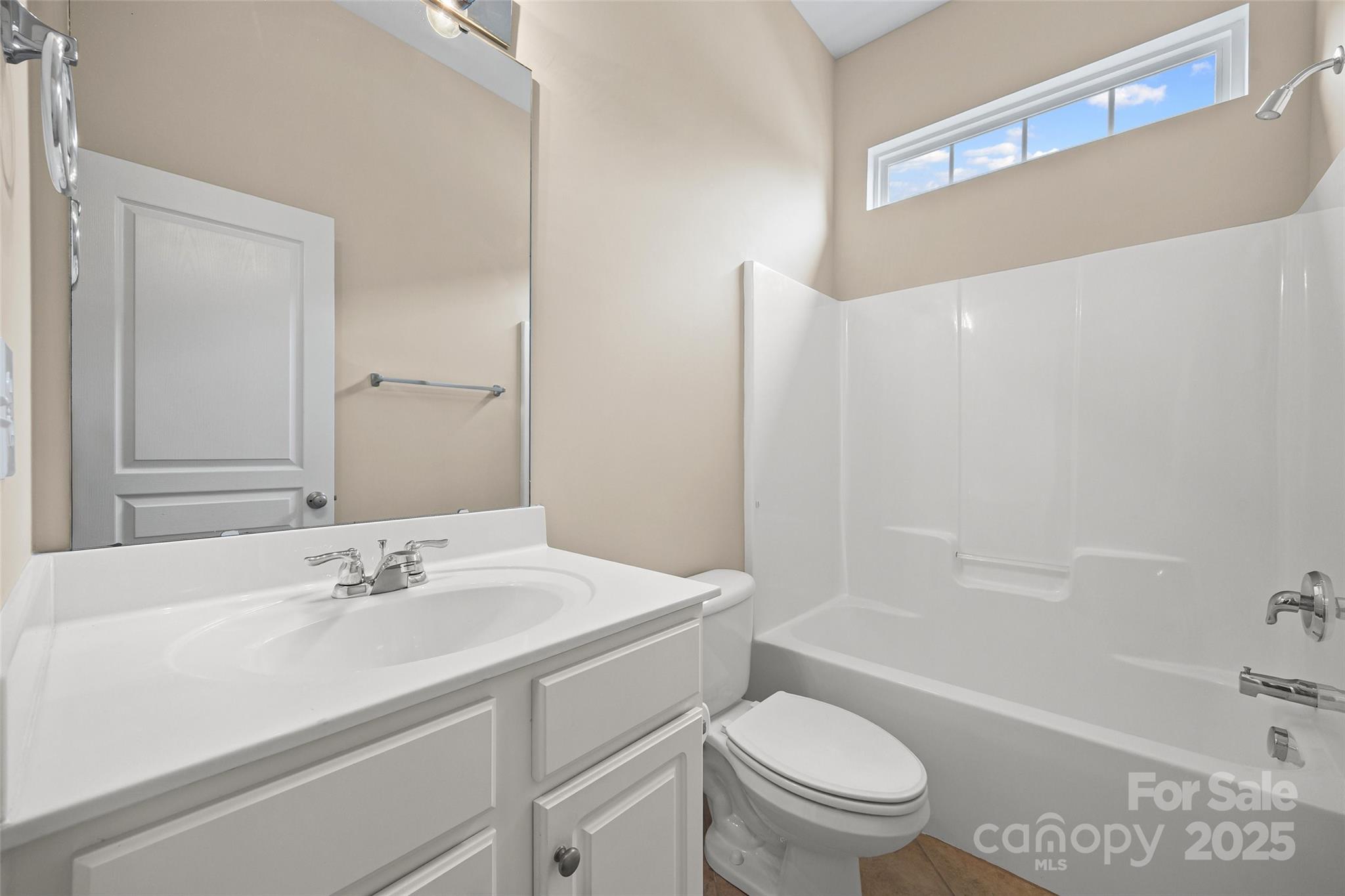 1033 Knob Creek Lane Tega Cay, SC 29708 - Photo 28 of 45 a bathroom with a sink a toilet and shower