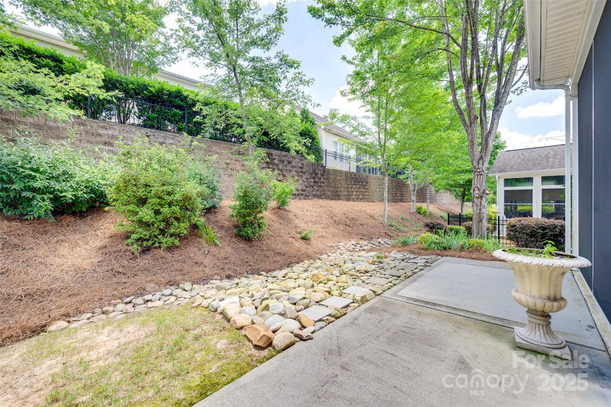1033 Knob Creek Lane Tega Cay, SC 29708 - Photo 41 of 45 a view of a backyard with sitting area and garden