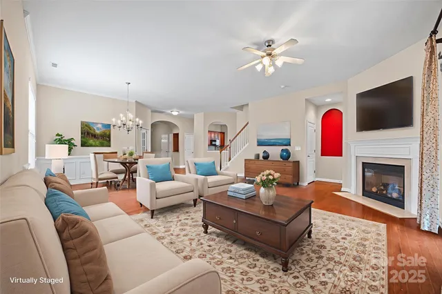 a living room with furniture a fireplace and a flat screen tv