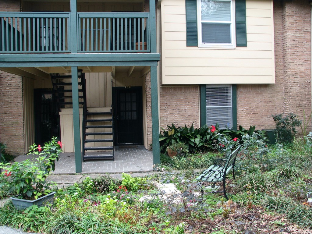 a view of a house with potted plants