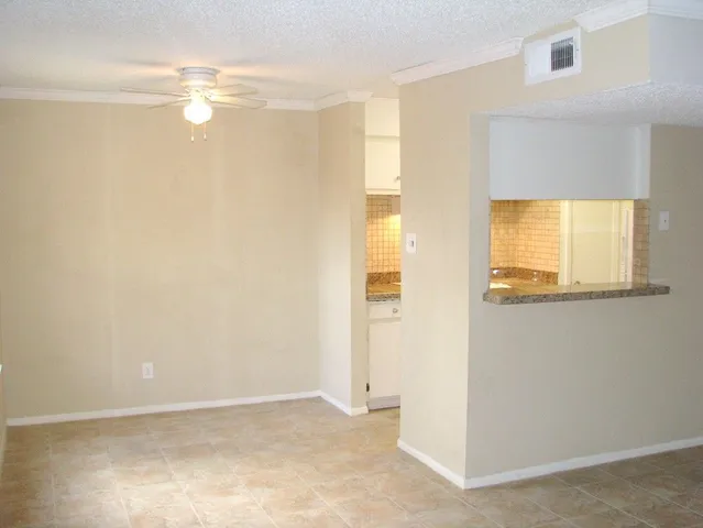 a view of a small space with wooden floor and a window