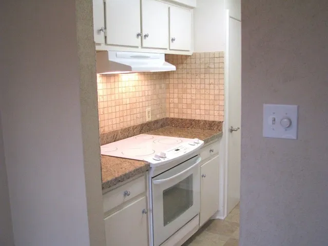 a stove top oven sitting inside of a kitchen
