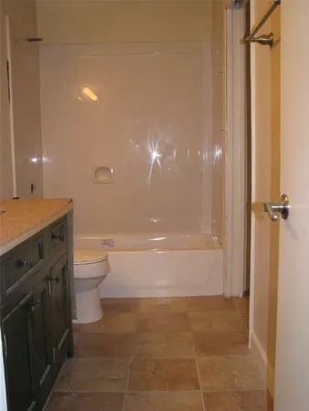 a bathroom with a toilet a sink and shower