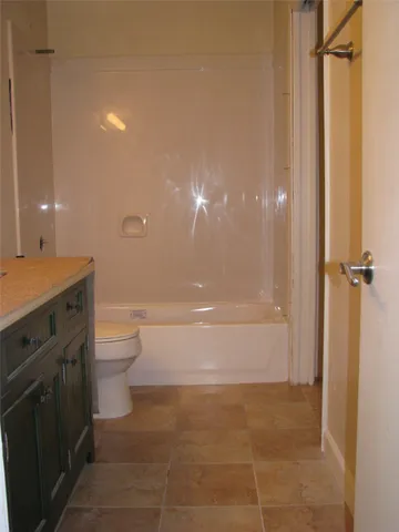 a bathroom with a toilet a sink and shower