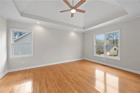 a view of an empty room with a window and closet