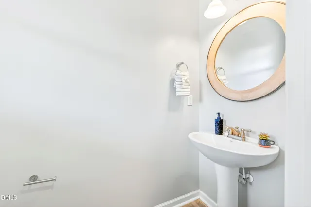 an empty room with ceiling fan and windows