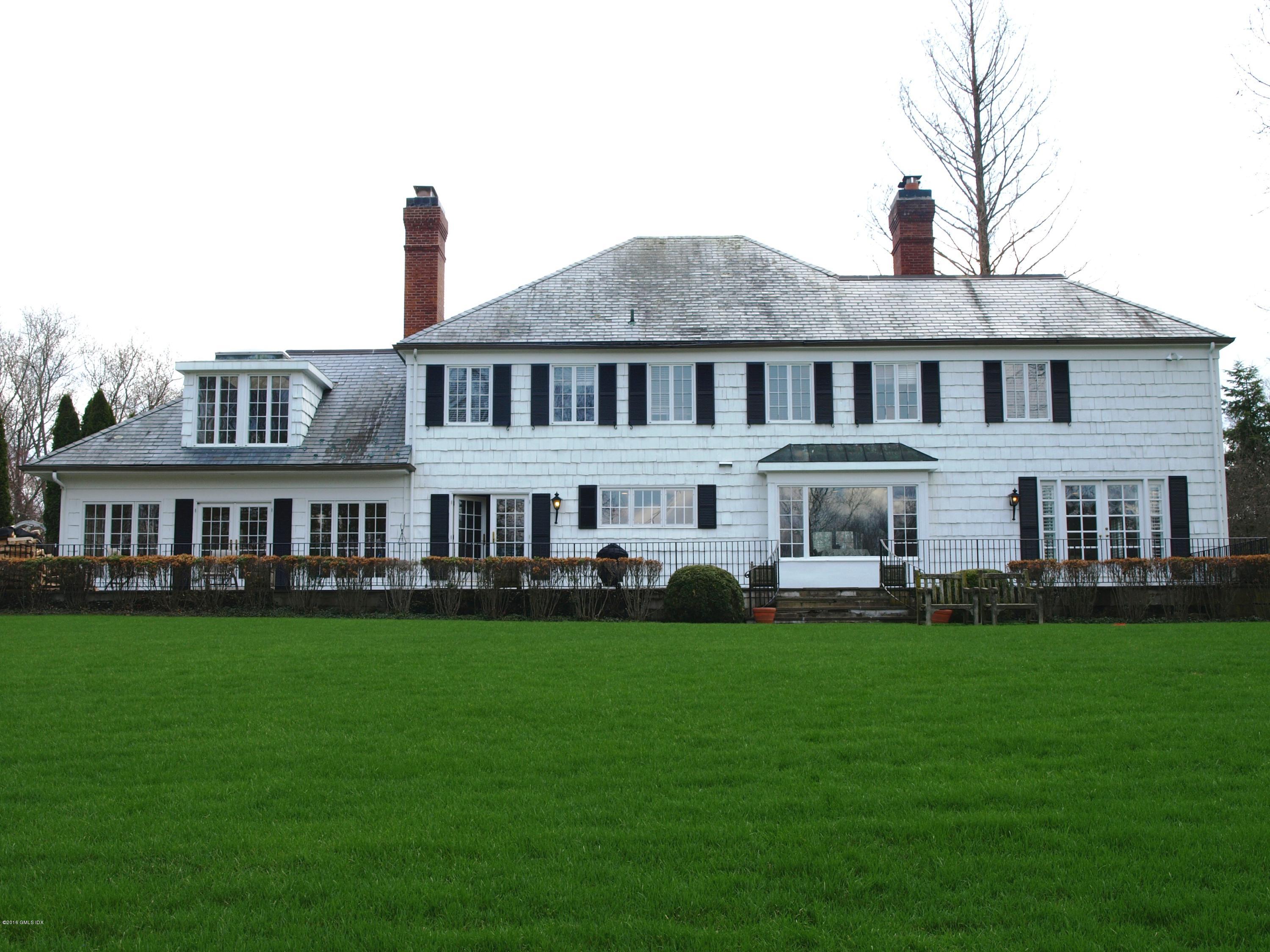 29 Lindsay Drive Greenwich, CT 06830 - Photo 12 of 17 a front view of a house with a garden and trees