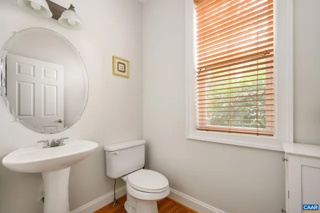 a bathroom with a sink a mirror and a toilet