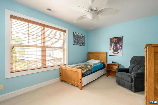 a bedroom with a bed couch and window