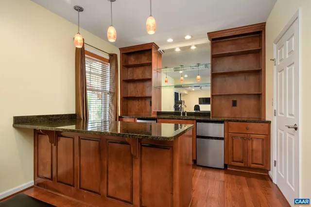 a living room with a table and a flat screen tv