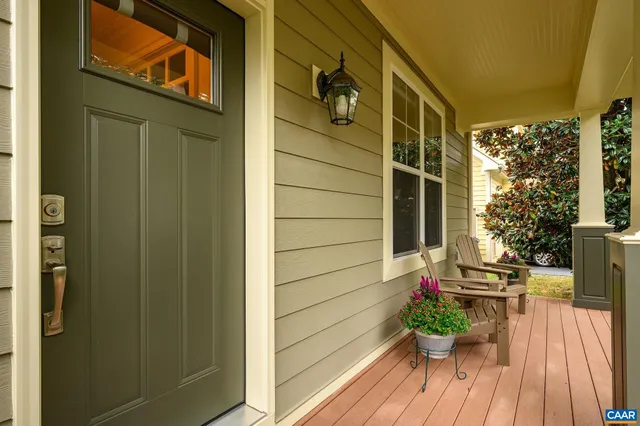 a view of a door with a potted plant and brick walls