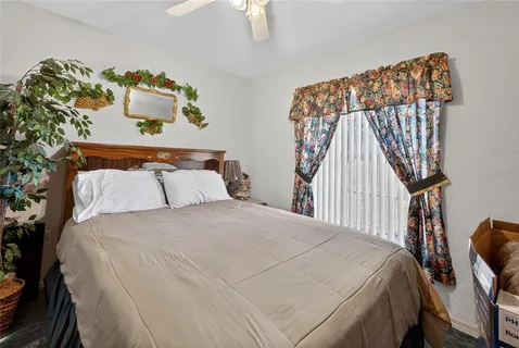 a bedroom with a bed and a painting on the wall