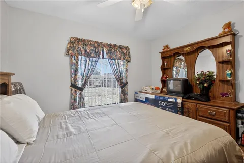 a bedroom with a bed and a mirror on dresser