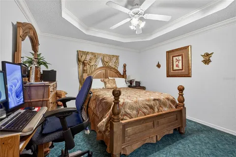a bed sitting in a bedroom next to a chandelier