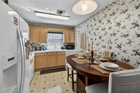 a kitchen with a sink stove and refrigerator