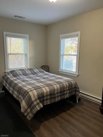 a bed sitting in a bedroom next to a window