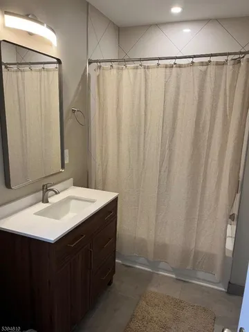 a bathroom with a double vanity sink and mirror