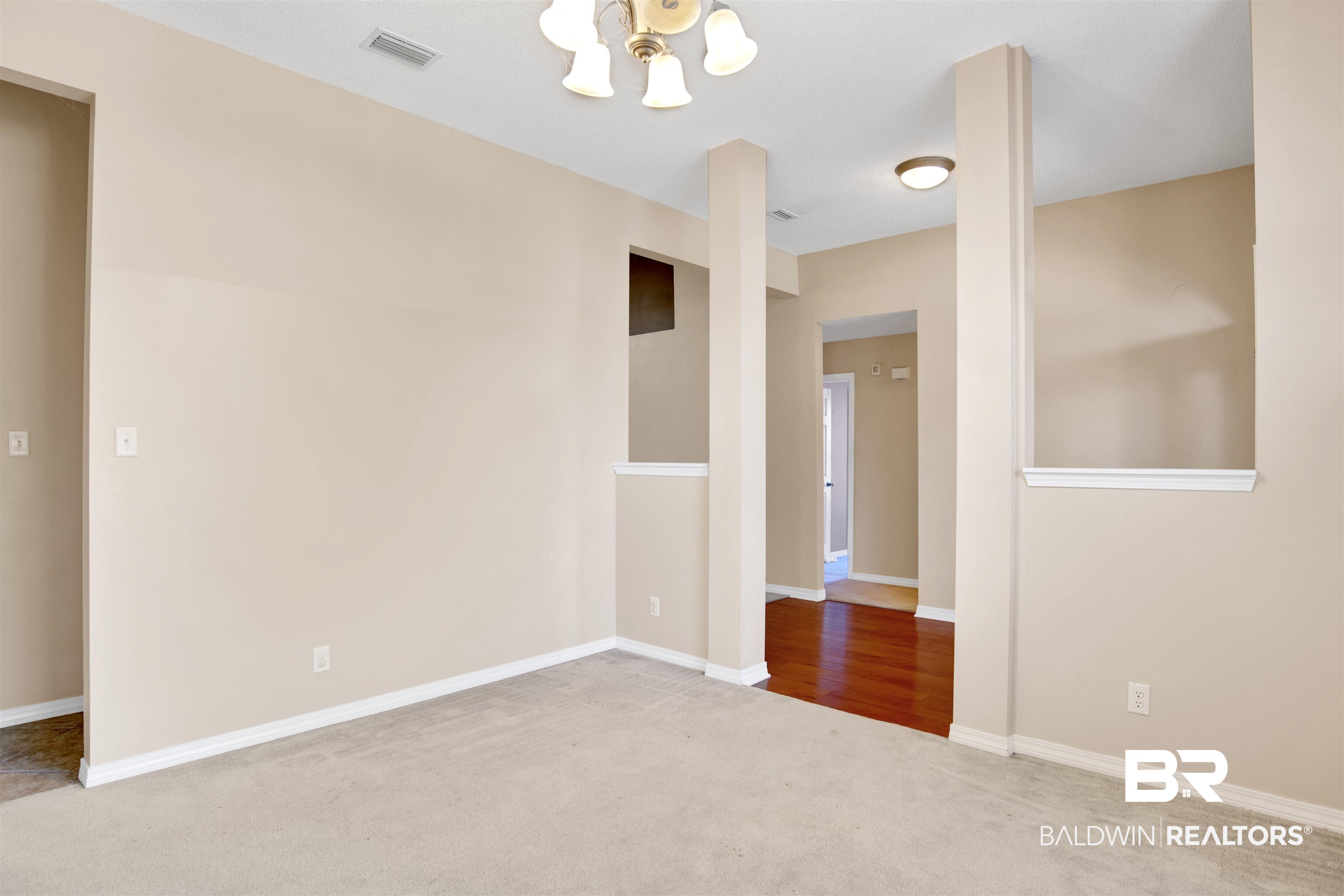 7297 Bridgemill Drive Mobile, AL 36619 - Photo 5 of 33 Carpeted spare room with baseboards and a chandelier