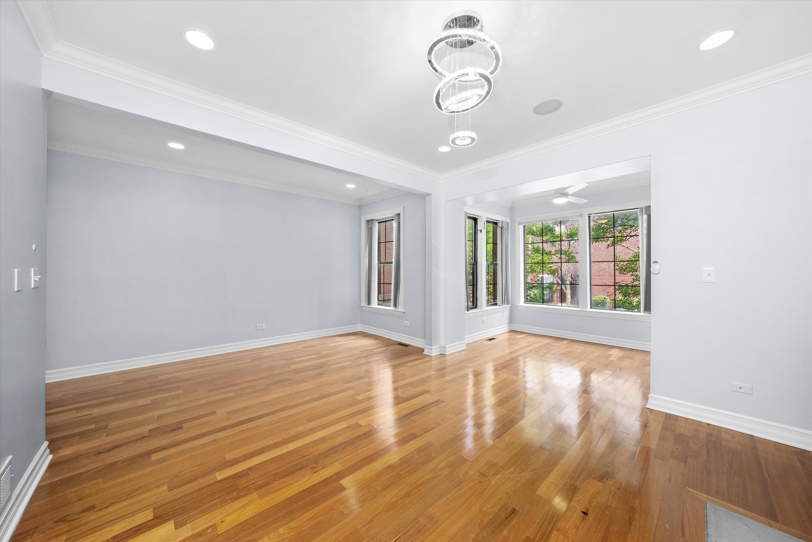 1363 East 64th Street, Unit 1 Chicago, IL 60637 - Photo 5 of 39 a view of an empty room with wooden floor and windows