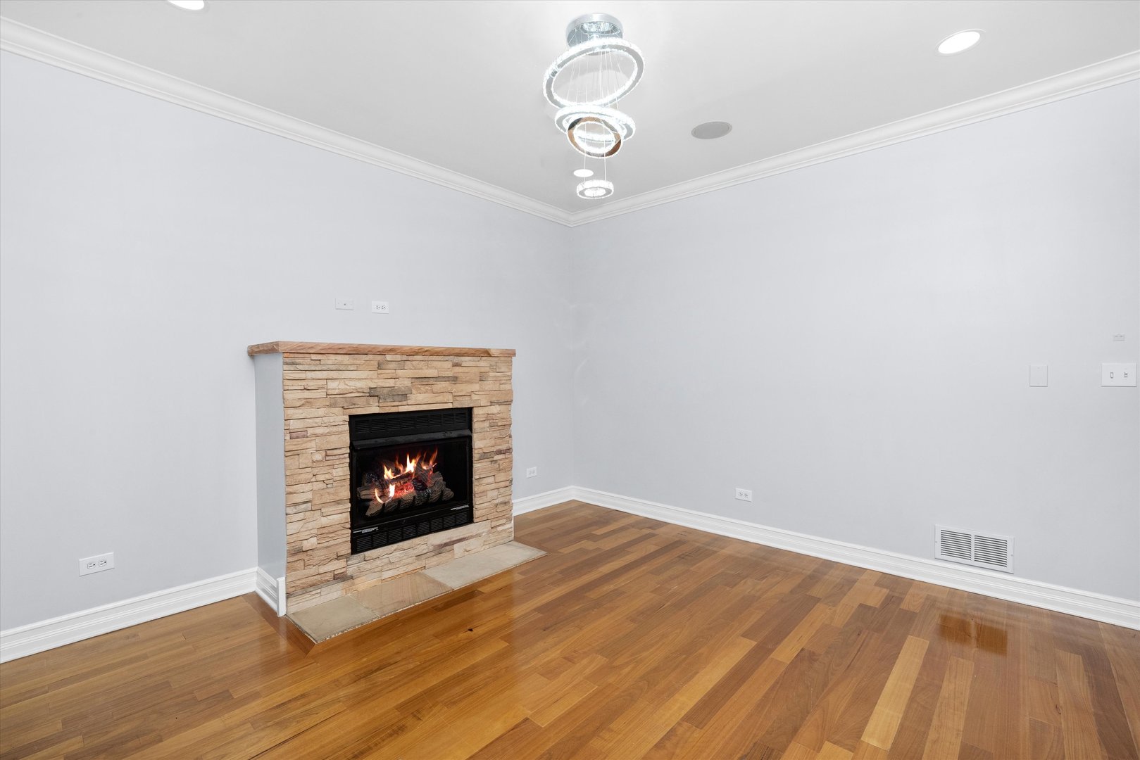 1363 East 64th Street, Unit 1 Chicago, IL 60637 - Photo 6 of 39 a view of an empty room with wooden floor fireplace and a window