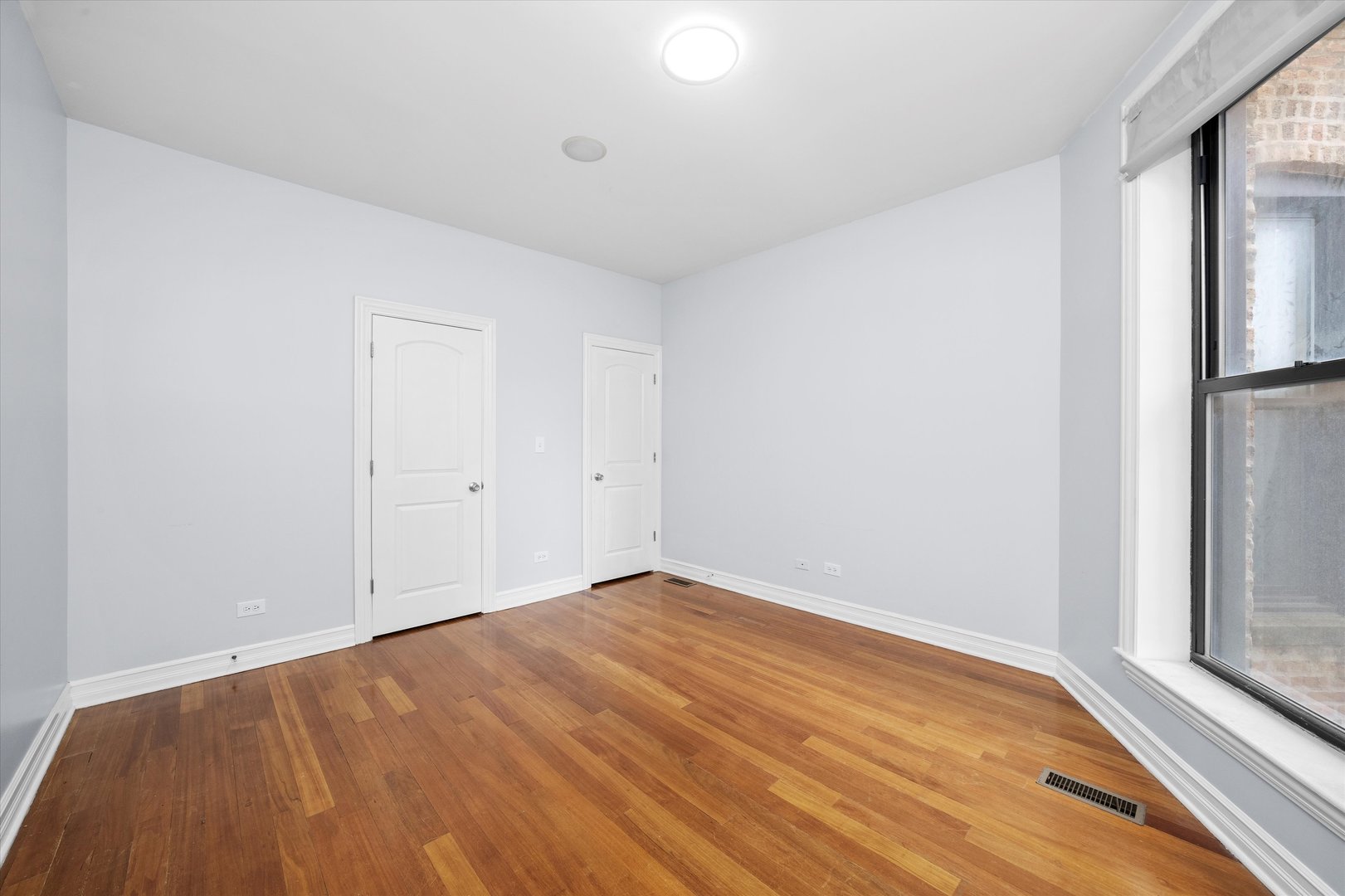 1363 East 64th Street, Unit 1 Chicago, IL 60637 - Photo 10 of 39 a view of empty room with wooden floor and fan