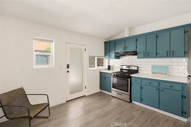 a kitchen with wooden cabinets and stainless steel appliances