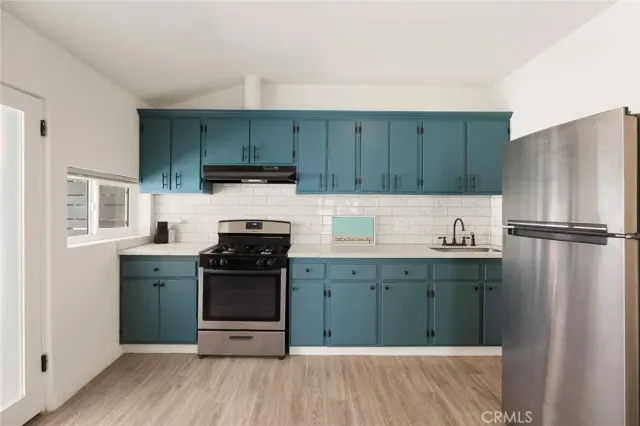 a kitchen with a sink and a refrigerator
