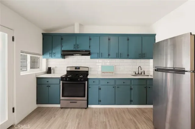 a kitchen with a sink and a refrigerator