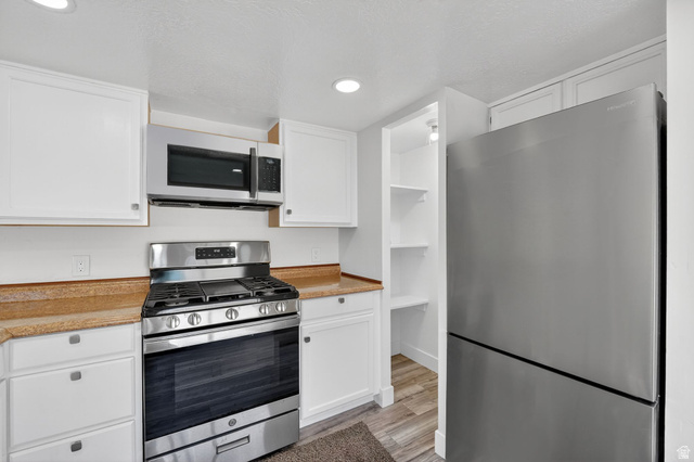 2491 Highway 89, Unit 523 Pleasant View, UT 84404 - Photo 11 of 31 Kitchen featuring stainless steel appliances, light countertops, white cabinets, and recessed lighting