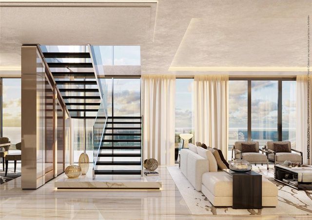 a living room with furniture and a floor to ceiling window