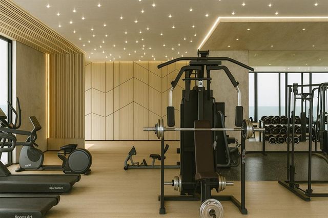 a room with gym equipment and glass door
