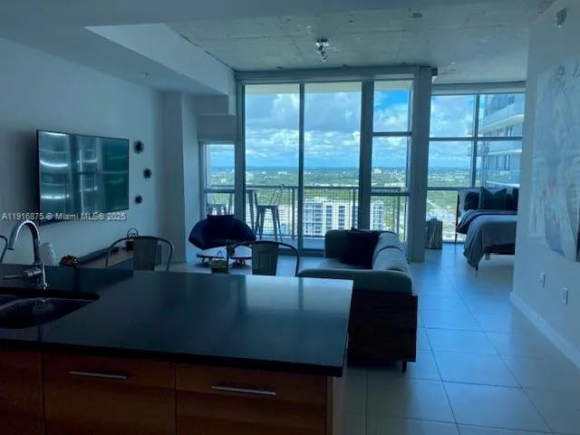 a living room with furniture and large windows