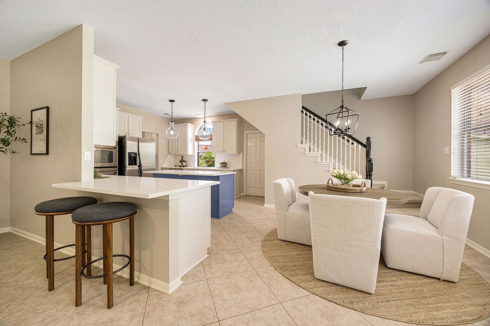 9603 Randon Lane Missouri City, TX 77459 - Photo 17 of 50 Stunning updated kitchen with Quartz counters, tile back splash, fresh paint and designer pendant island lighting.