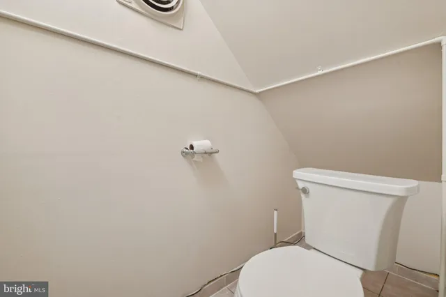 a white toilet sitting next to a shower