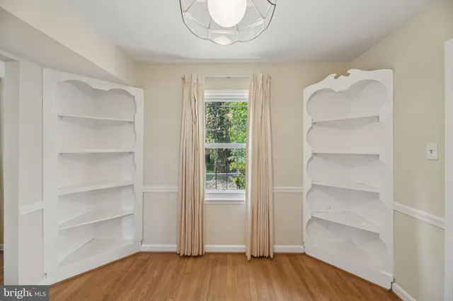 a view of a room with a wooden floor and a window