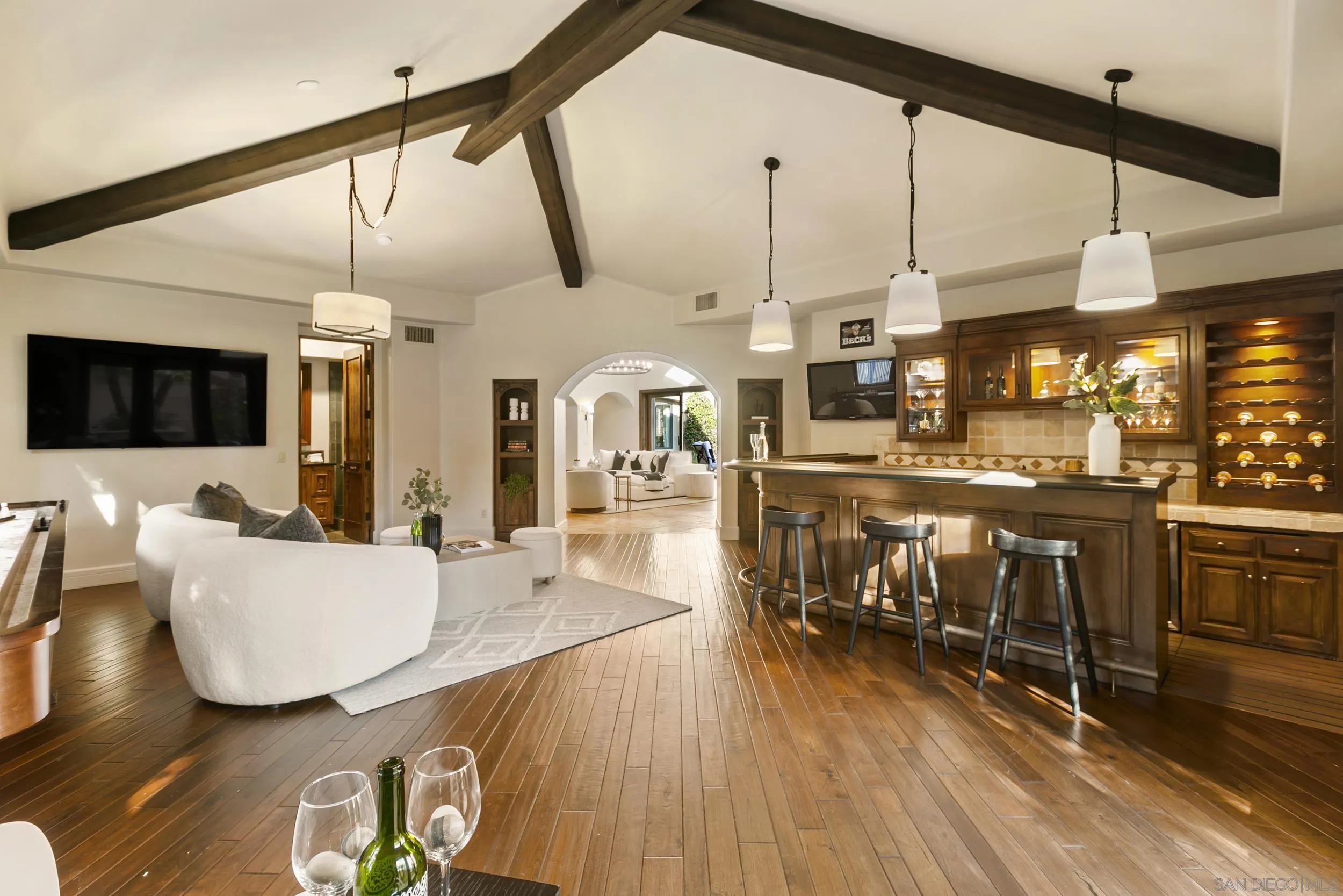 6089 Avenida Alteras Rancho Santa Fe, CA 92067 - Photo 8 of 23 a living room with stainless steel appliances kitchen island granite countertop a table chairs and a wooden floor